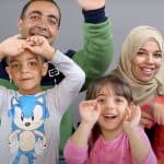 A photo of a Syrian family smiling for the camera