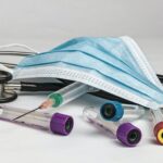 Medical equipment (stethoscope, syringe, vial, mask).