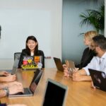 A group of diverse employees at a conference table during a meeting